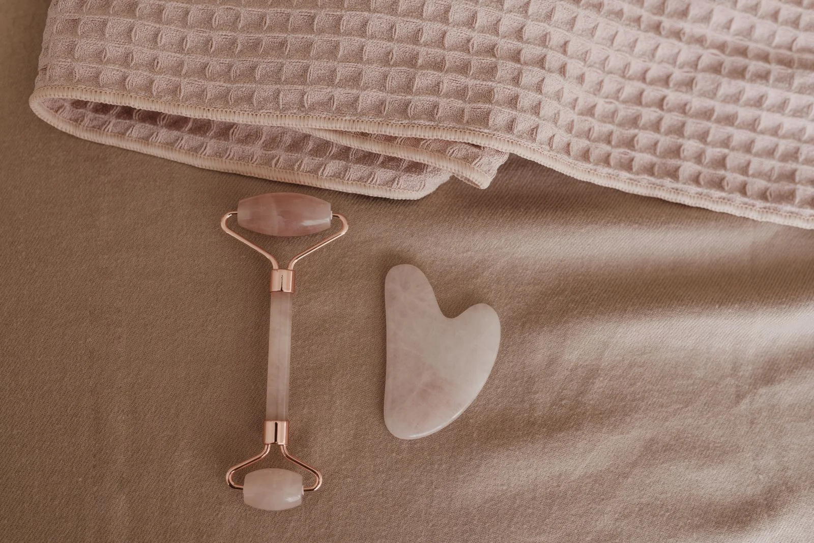 Rouleau quartz rose et gua sha sur tissu doux — forme soignée